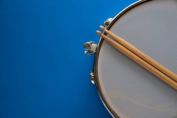 istock Drum stick and drum on blue table background, top view, music concept 1450328890