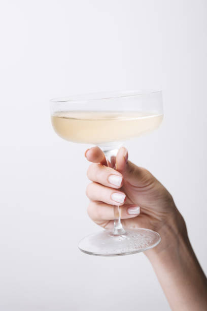 Hand holds glass goblet with champagne stock photo