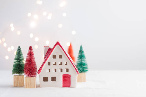 istock Ceramic christmas house with spruce on the white background with lights 1450329200