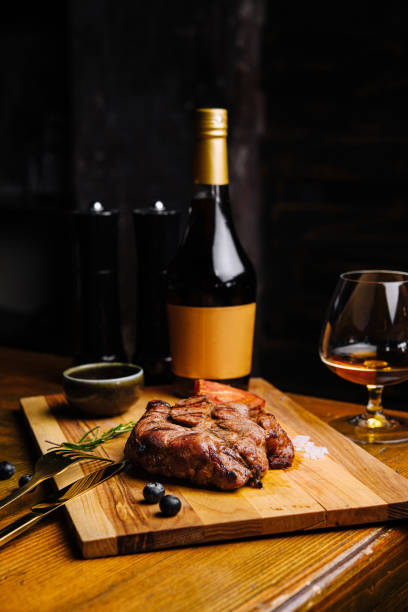 istock Grilled t-bone steak and whiskey glass in a restaurant table 1450329764