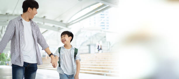 istock Boy and his father in city. 1450330122