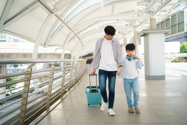 istock Boy and his father in city. 1450330330