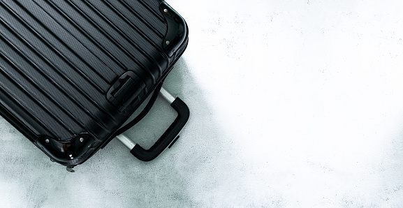 Top view of luggage and text space,Top view of a suitcase [on a white background,Black luggage set on dark background, top view image, flat lay composition. Travel minimalist concept, black and dark classic baggage mockup, small and big. Suitcase accesso