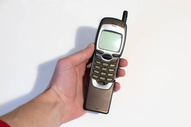 istock Old mobile phone slider in man's hands. Pastime, Retro technology. 1450332099