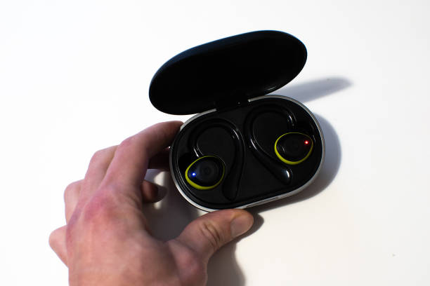 istock Man is holding black wireless headphones. Modern technology concept. 1450332127