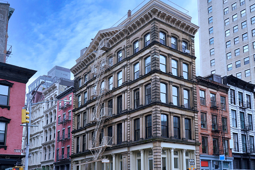 New York, Old buildings in Tribeca district, with distinctive roof cornices and external fire escape