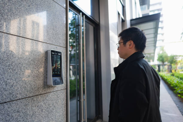 istock Man uses facial recognition technology to unlock door 1450334234
