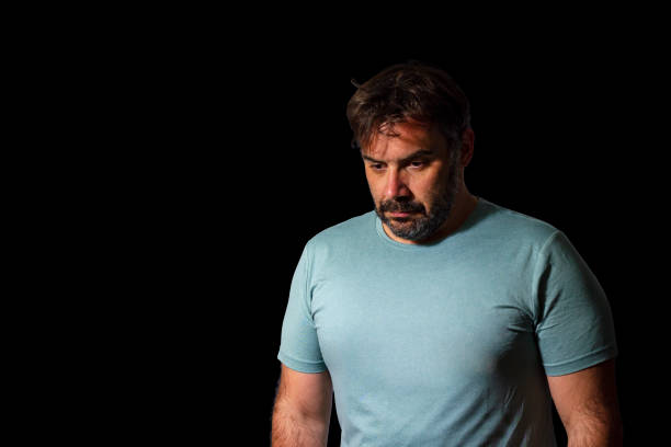 istock Upset and sad man posing isolated on black background studio portrait. 1450334254