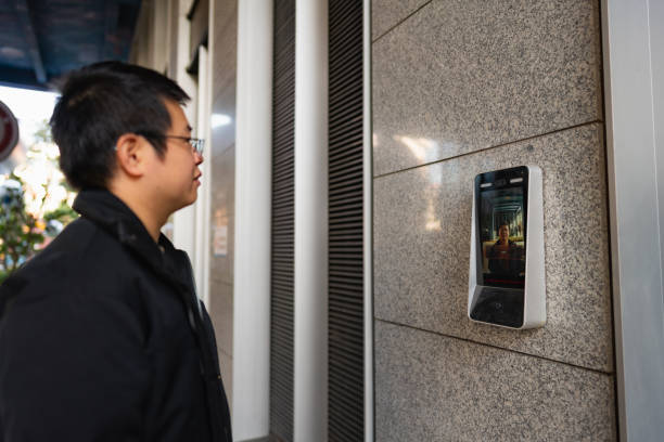 istock Man uses facial recognition technology to unlock door 1450334340