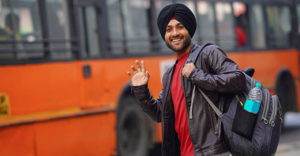 istock Young Sikh man carrying a bag and going college 1450335835