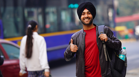 Giving Tumbs up Men with books and bag Indian sikh Happy college student