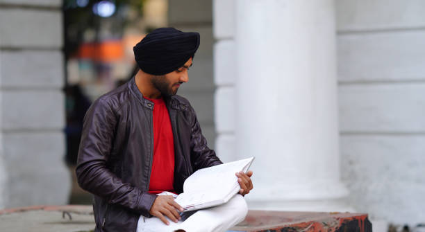 istock handsome sikh writer boy in writing or reading 1450335874
