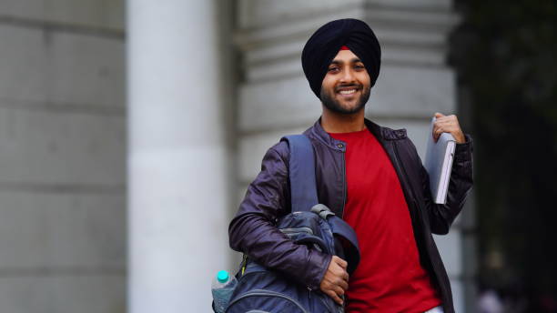 istock sikh college student image Happy Young sikh punjabi boy with confidence and bag 1450335921