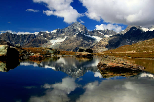 istock A smooth Riffelsee lake surface and mountains and clouds reflected in it, on a mountain Gornergrat, near Zermatt, in southern Switzerland 1450341610