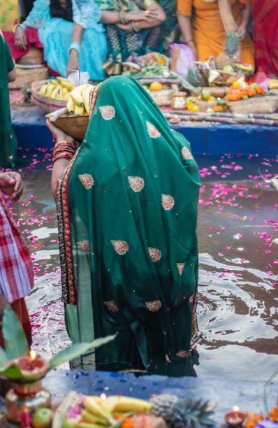 istock devotee praying with religious offerings for sun god in Chhath festival 1450345655