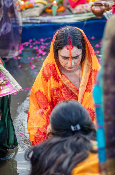 istock devotee praying for sun god during Chhath festival from flat angle 1450345723