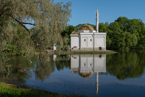 The pavilion of the Turkish Bath on the shore of a Large pond in the Catherine Park in Tsarskoye Selo on a sunny summer day, Pushkin, St. Petersburg, Russia