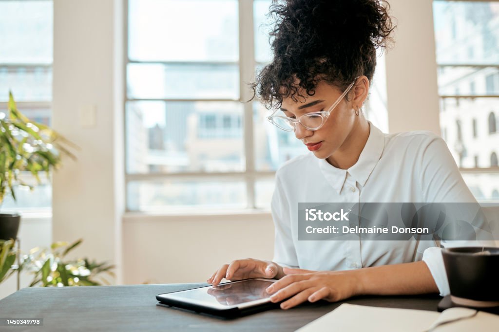 Tablet, online and black woman in office, social media or connect for conversation, typing or chat. Entrepreneur, African American female or confident girl with device to search internet or workplace Brand Name Online Messaging Platform Stock Photo