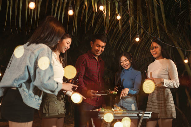 istock Asian group friends happy dinner party bbq on grill. 1450350509
