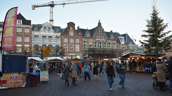 Haarlem Christmas Market In North Holland The Netherlands Europe, Building Exterior, Christmas Decorations, Christmas Tree, Variety Of Items On Display For Sale, People Walking Around, Looking For Items To Buy, Eating And Drinking, Talking To One Another Scenery. Photographed With Nikon D7200 24 Megapixel DSLR Camera