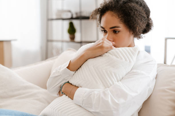 istock Young woman thinking about abortion while sitting on sofa at home 1450351426