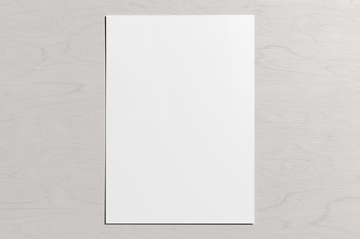 Blank sheet of paper mock up on the white wooden table.