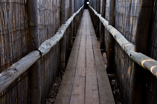 A wooden walkway with a wooden handrail. Goal concept