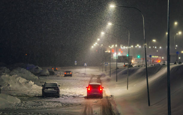 istock Falling snow in city. Winter weather. 1450355641