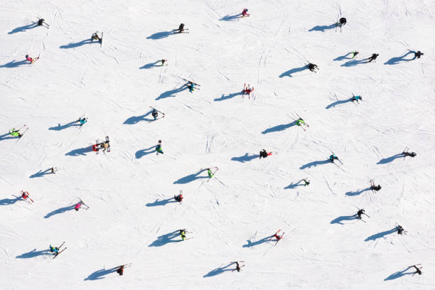 Ski resort. Aerial view of skiers and snowboarders. Winter sports. stock photo