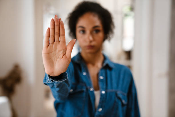 istock Young black woman gesturing stop sign and protesting against abortion 1450356541