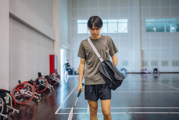 istock Young disabled athlete standing on badminton court. 1450357523