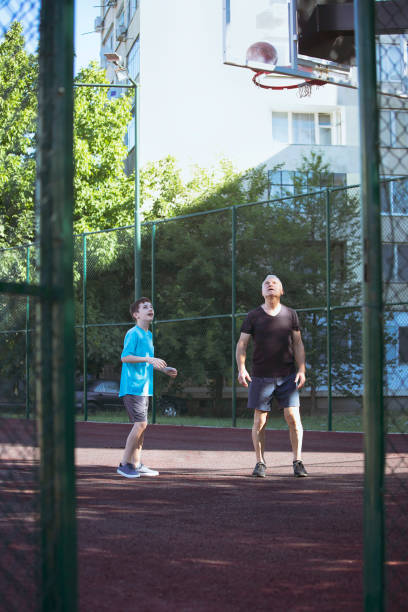 istock Happy grandfather and grandson practicing basketball 1450358130