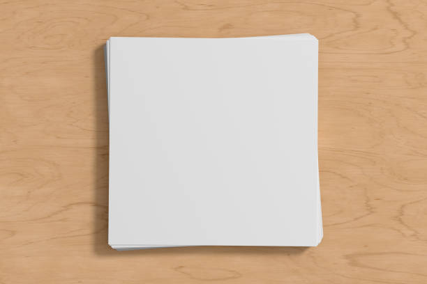 istock Stack of square sheets of paper on the wooden table. 1450358147