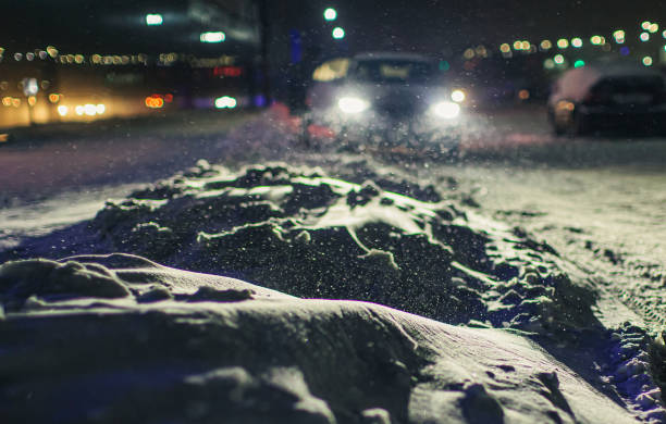 istock Falling snow in city. Winter weather. 1450358370
