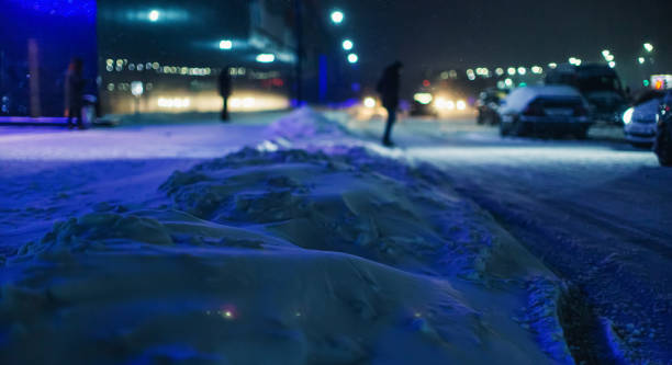 istock Falling snow in city. Winter weather. 1450358495
