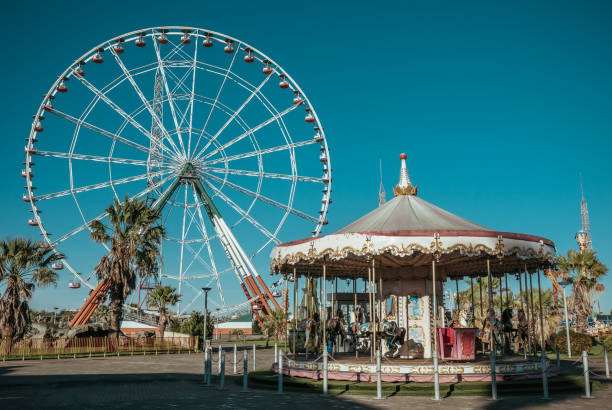 ferris wheel and empty rides in amusement park without people - amusement park imagens e fotografias de stock