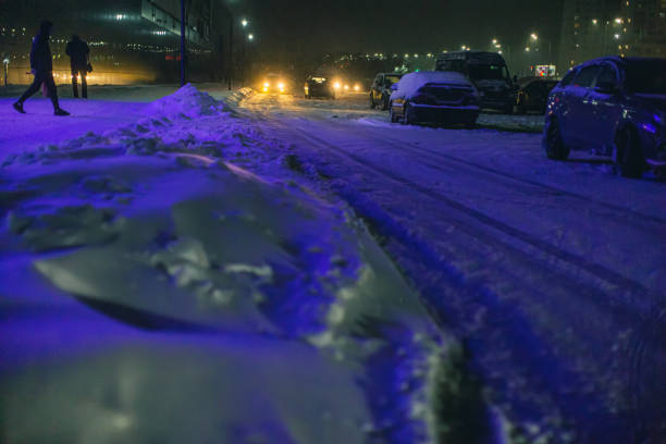 istock Falling snow in city. Winter weather. 1450359133