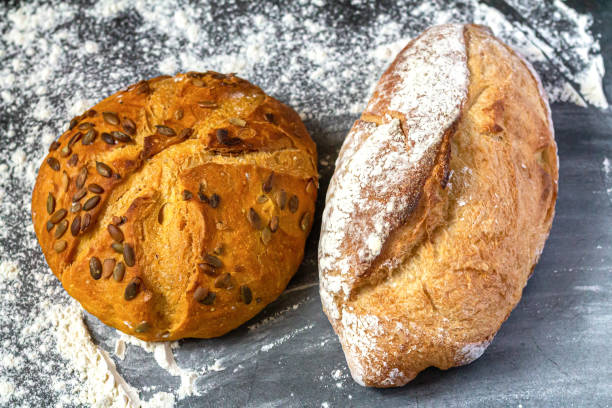 istock Bakery background with baked bread on flour table 1450359943