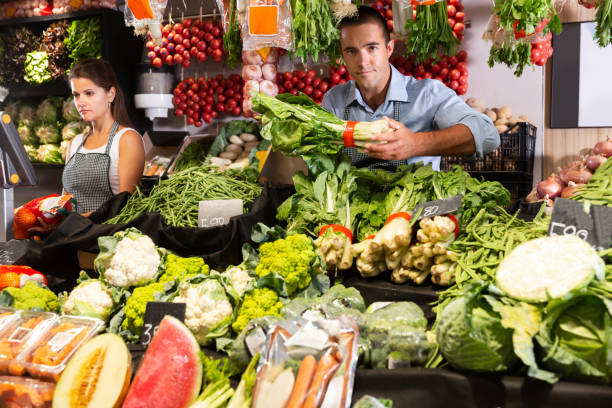 istock Man selling fruits and vegetables 1450360276