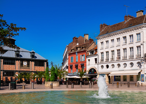 Cityscape of old French town of Sens with shops and outdoors cafe at summer