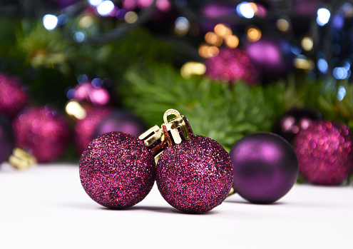 Purple baubles decoration with lights still life stock photo. Purple shiny christmas ornament image