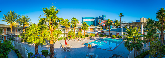 Panoramic views across the palm trees and blue pool of hotels, motels and casinos on the Las Vegas Strip, Nevada.