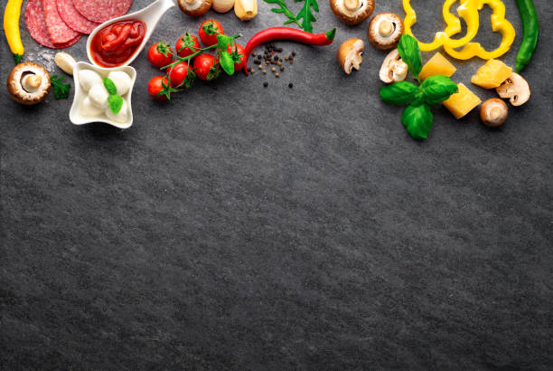 istock Set ingredients for cooking italian pizza on dark stone background with copy space, top view 1450365564