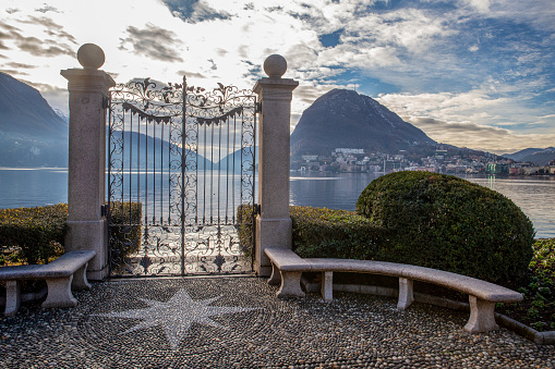 Park Cioni and  view on lake Lugano in sunny day of winter - topiary bushes (maybe of boxwood)