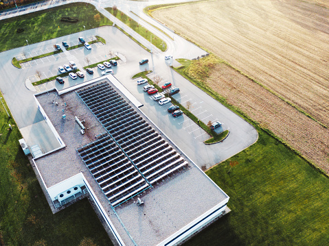 Aerial view of industrial building with a large parking lot somewhere in the countryside of Slovenia.