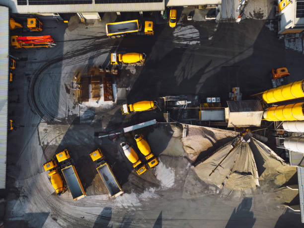 istock Top down view at a construction site company base with yellow heavy machinery 1450367705