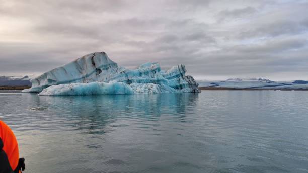 istock Floating icebergs in the water against a cloudy sky 1450368351