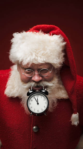 istock Santa claus with alarm clock 1450368492