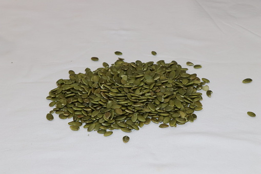 Organic Pumpkin seeds isolated on white, close up of pumpkin seeds.