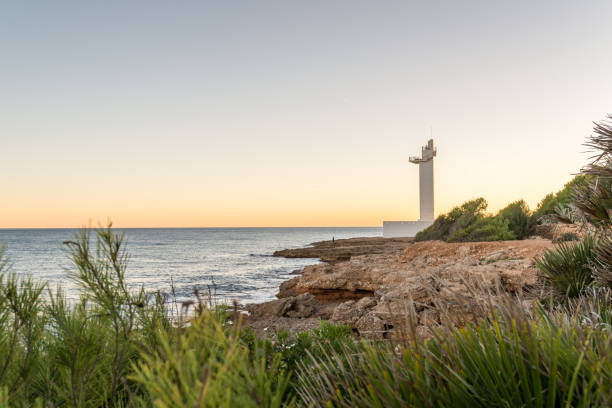 istock Mediterranean coast with a lighthouse on the background at sunset. 1450371401